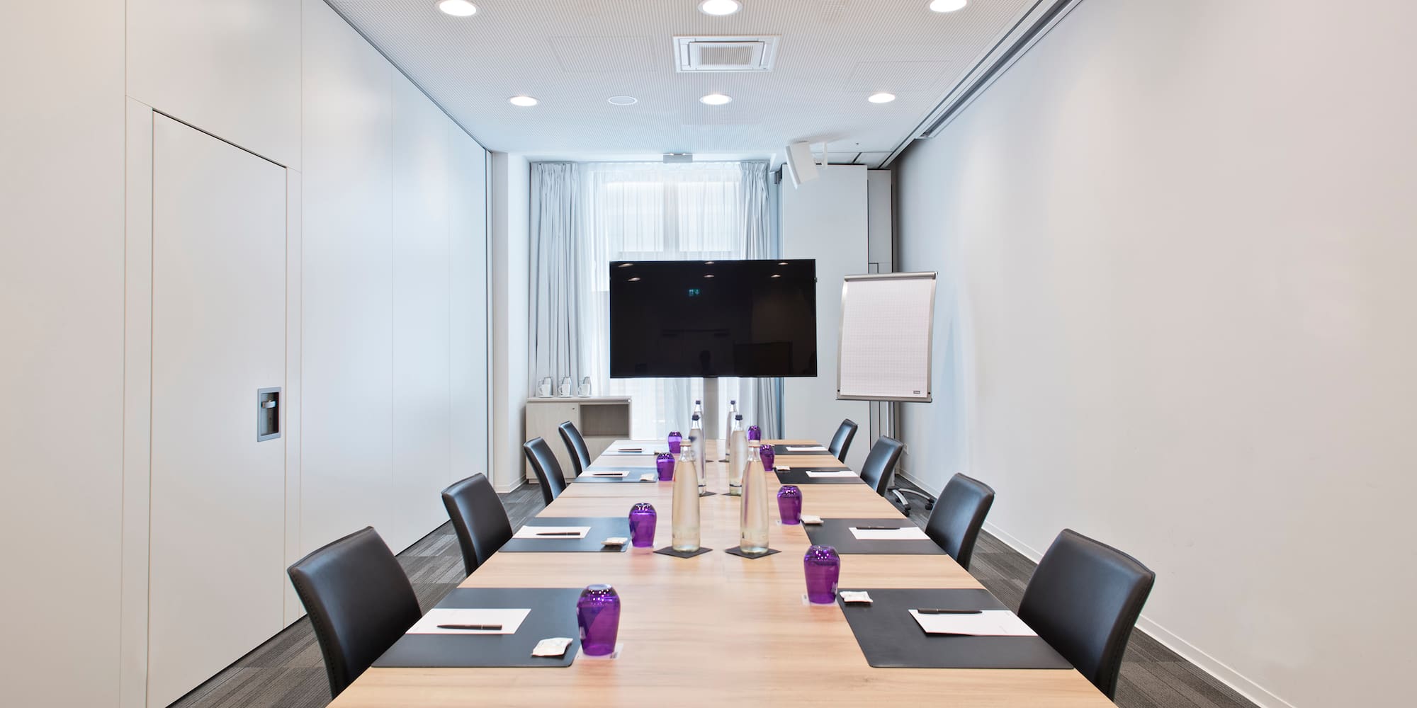 a conference room with a table and chairs