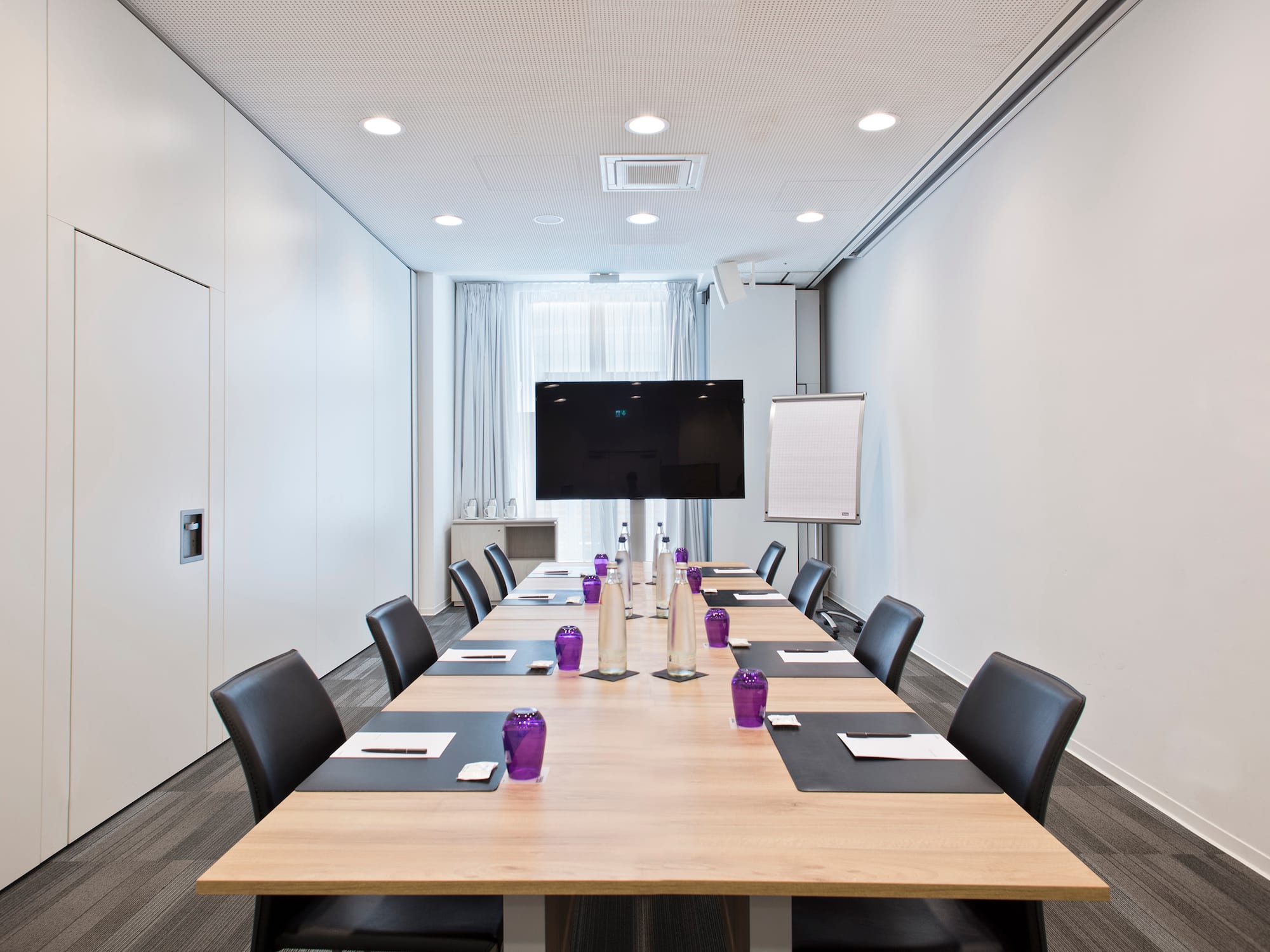 a conference room with a table and chairs