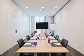 a conference room with a table and chairs