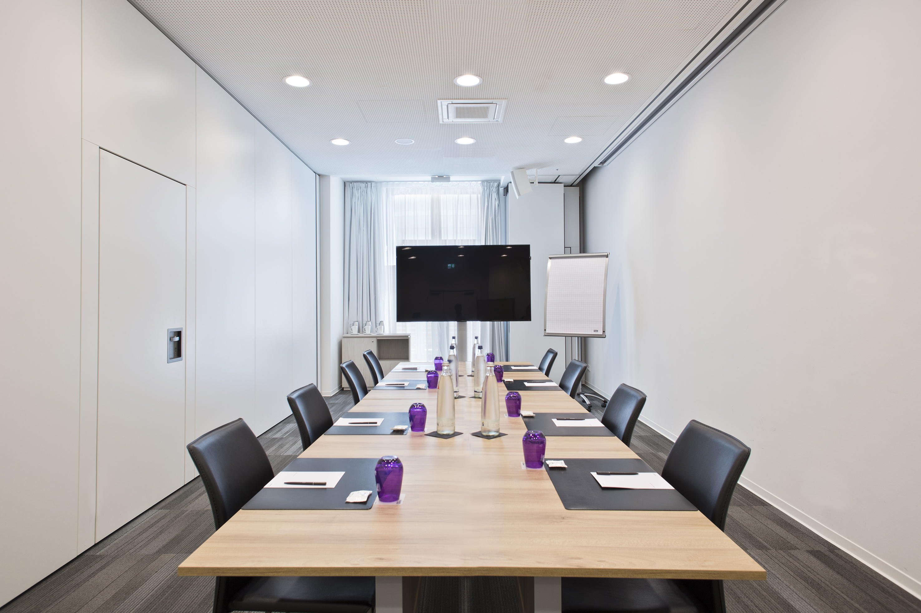 a conference room with a table and chairs