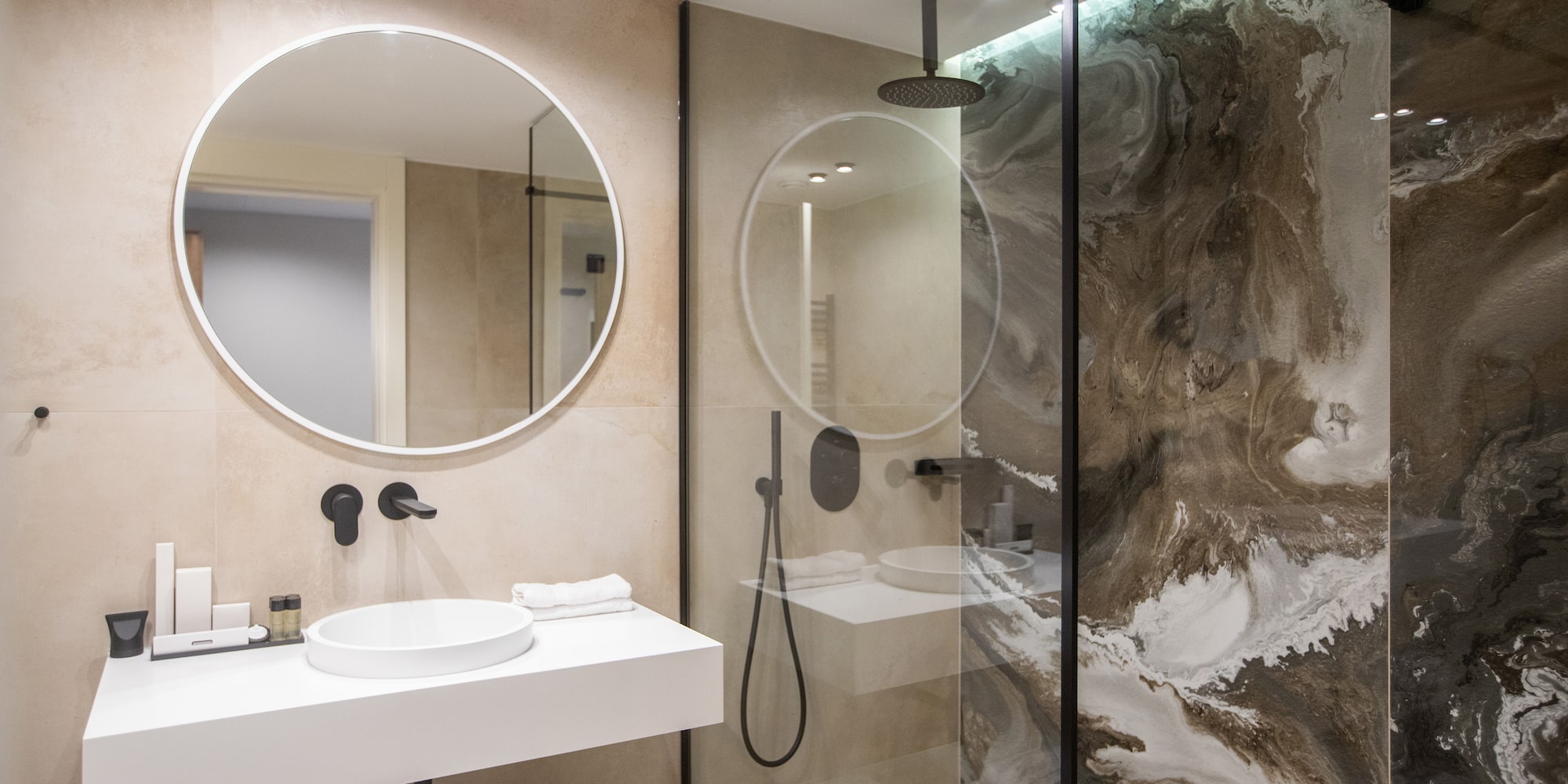 a bathroom with a glass shower and sink