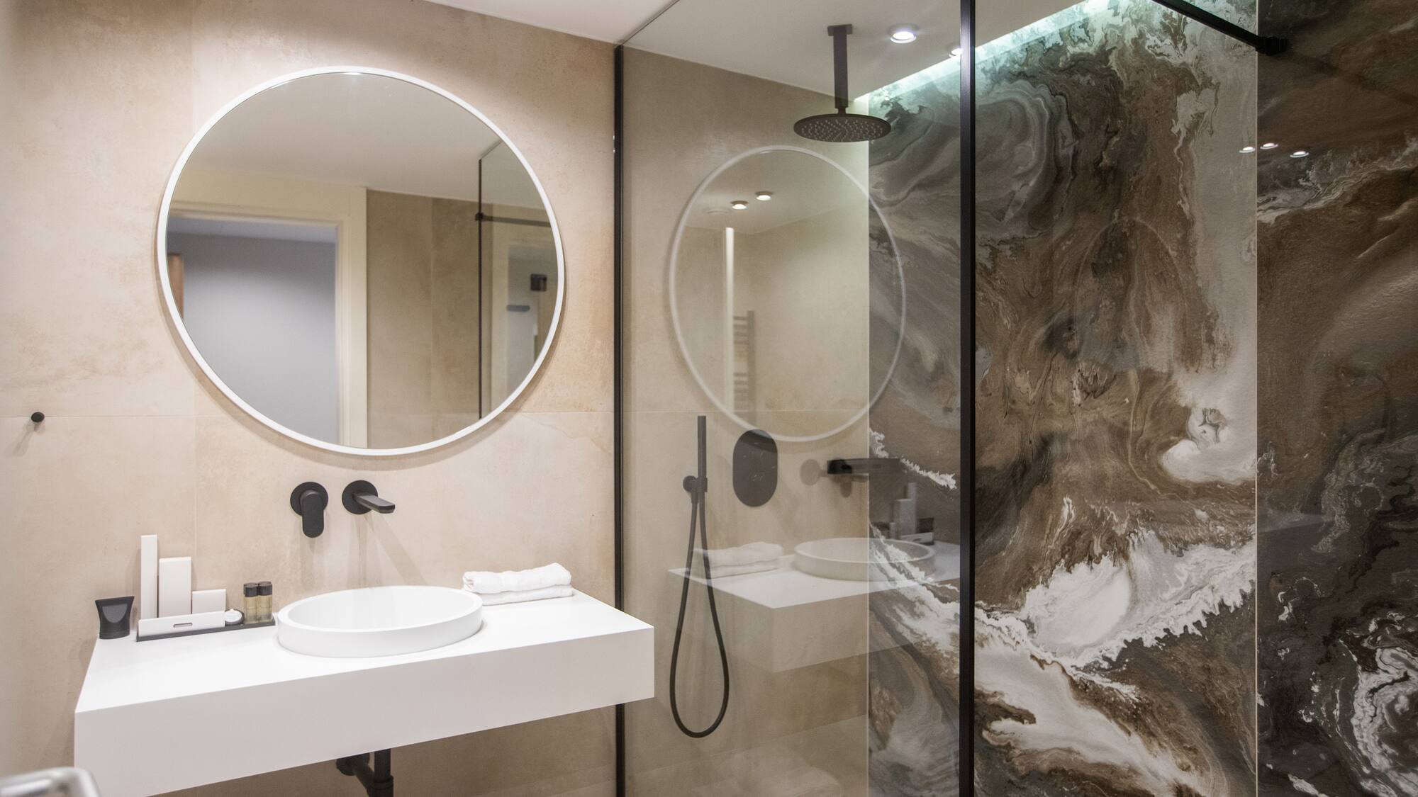a bathroom with a glass shower and sink