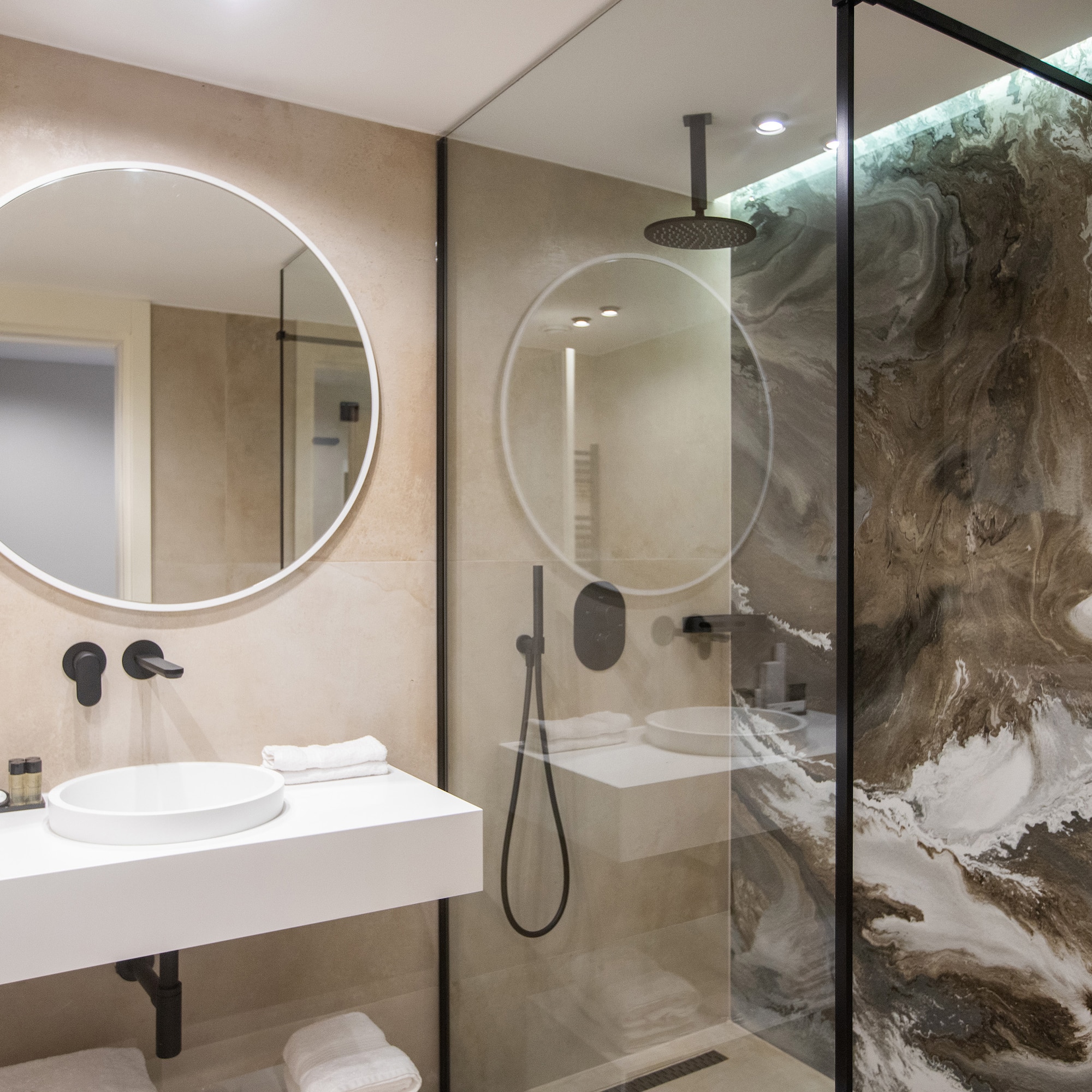 a bathroom with a glass shower and sink
