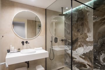 a bathroom with a glass shower and sink