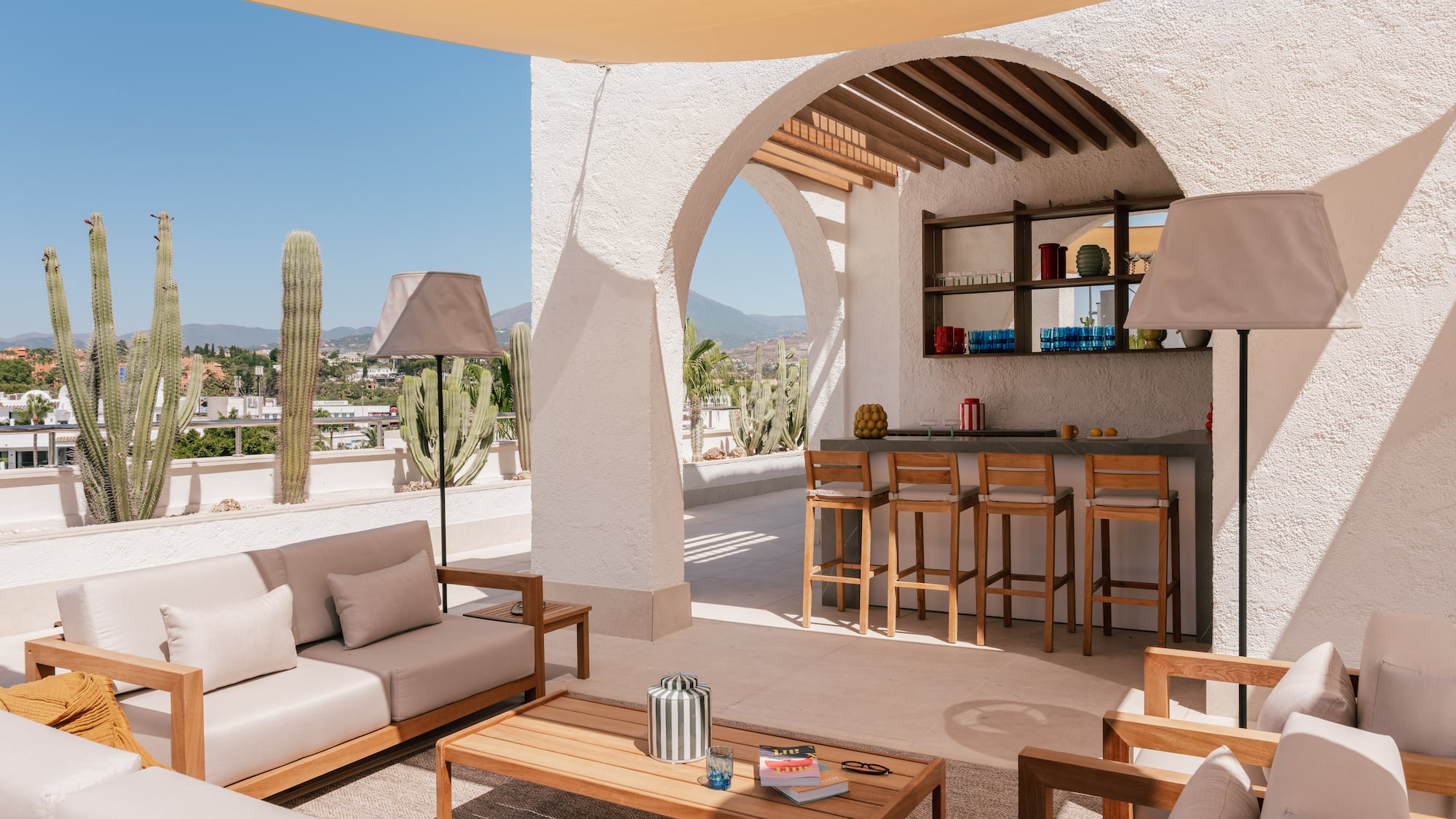 a patio with a bar and chairs