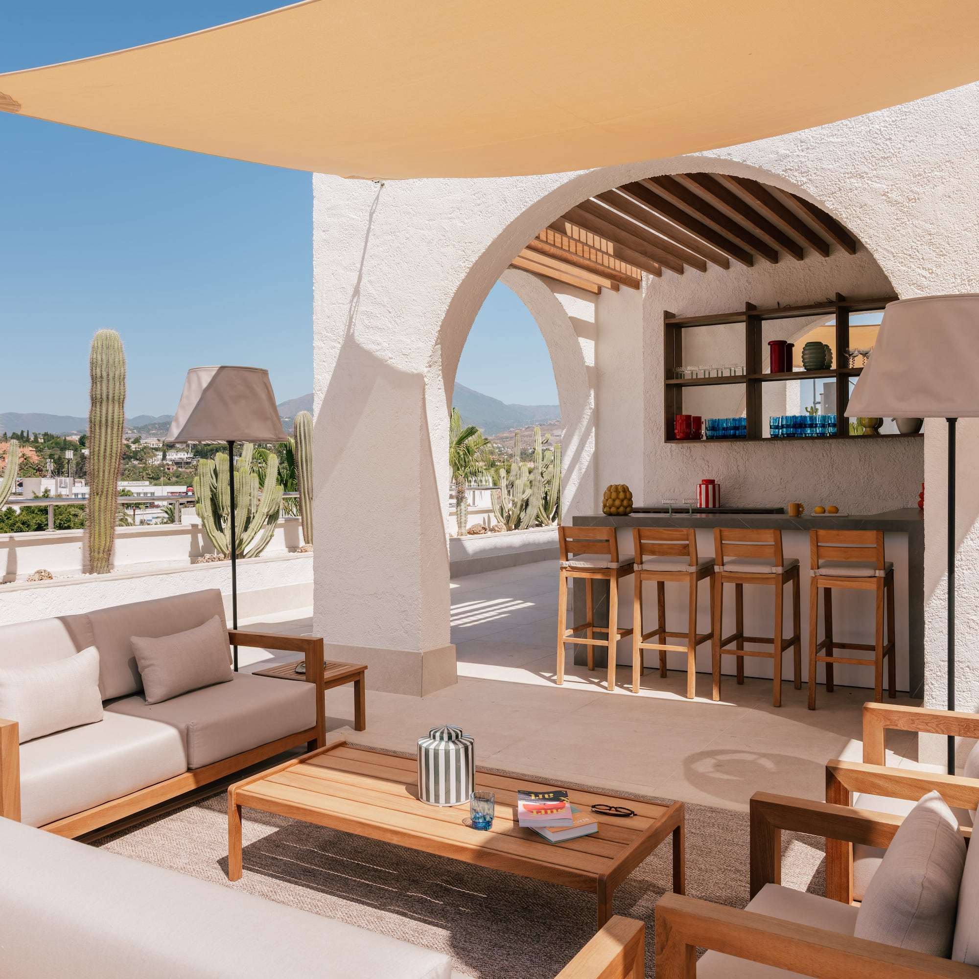 a patio with a bar and chairs