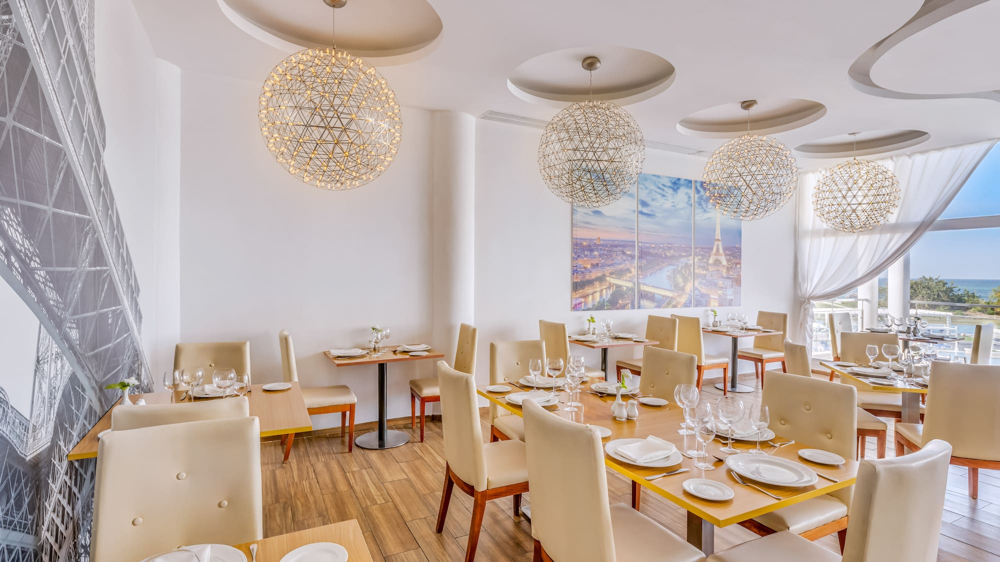 a room with tables and chairs and a painting on the wall