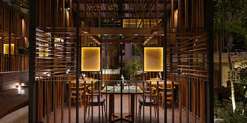 a wooden structure with a table and chairs