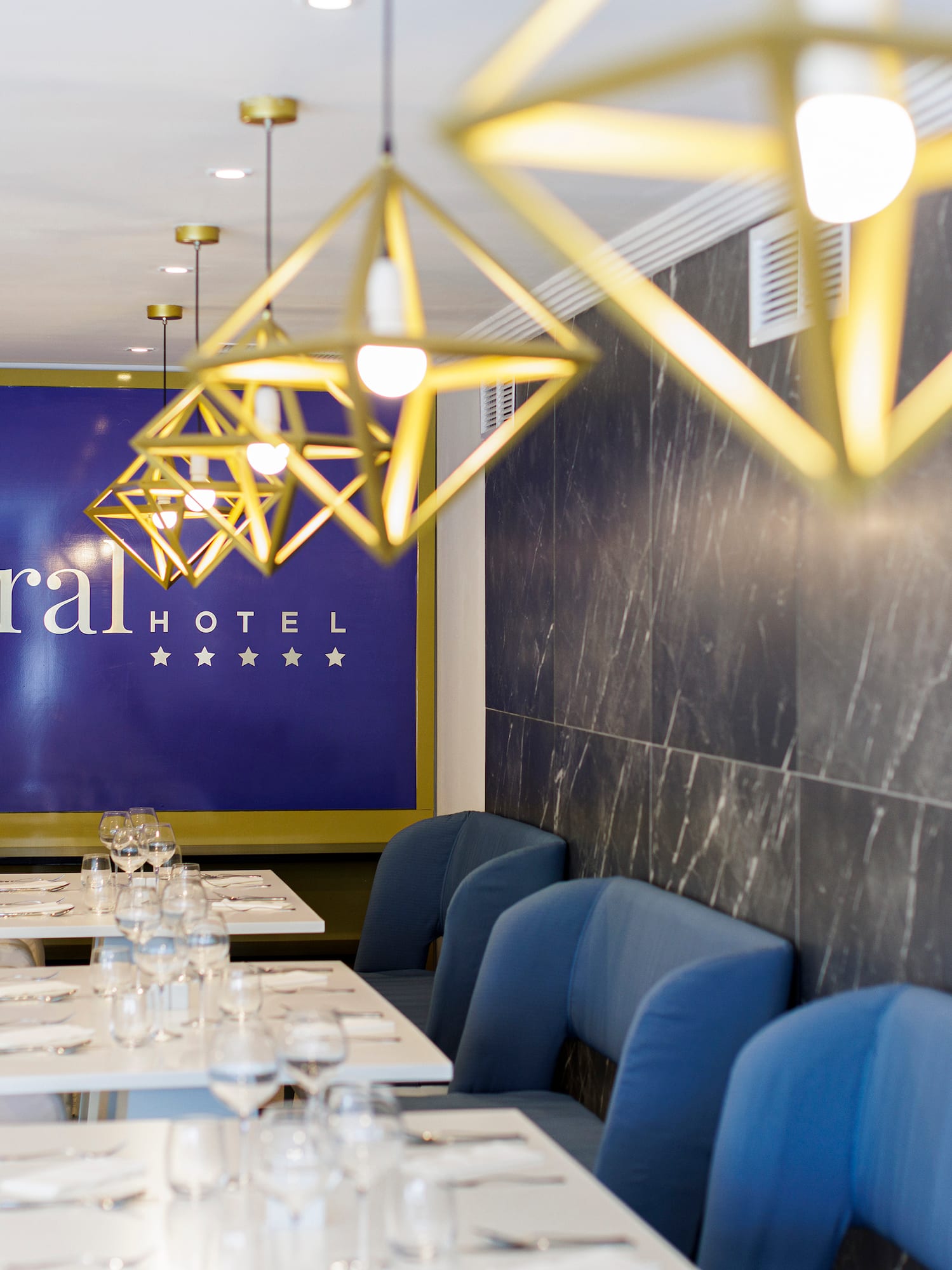 a restaurant with blue chairs and white tables