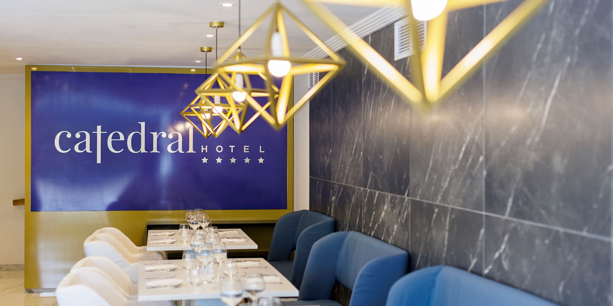 a restaurant with blue chairs and white tables