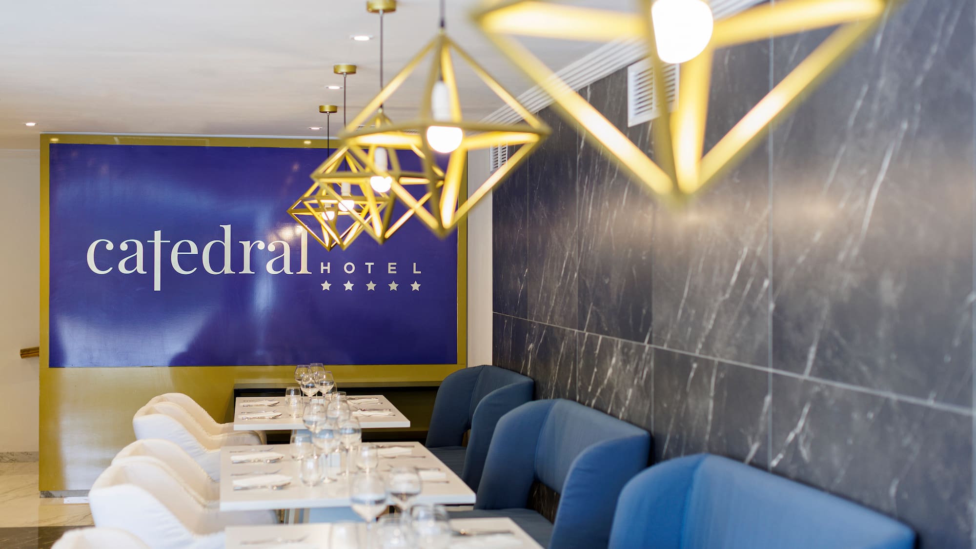 a restaurant with blue chairs and white tables