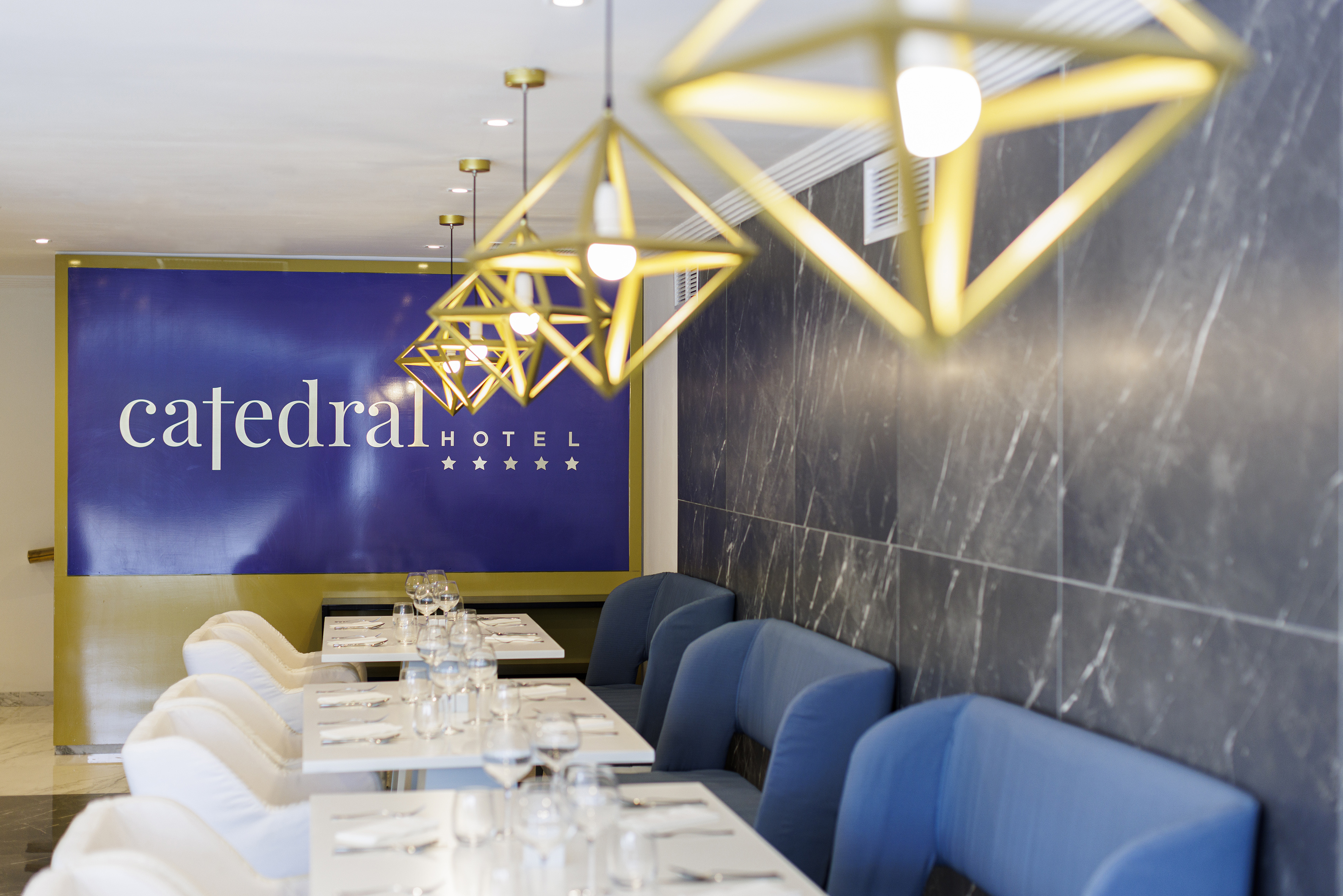 a restaurant with blue chairs and white tables