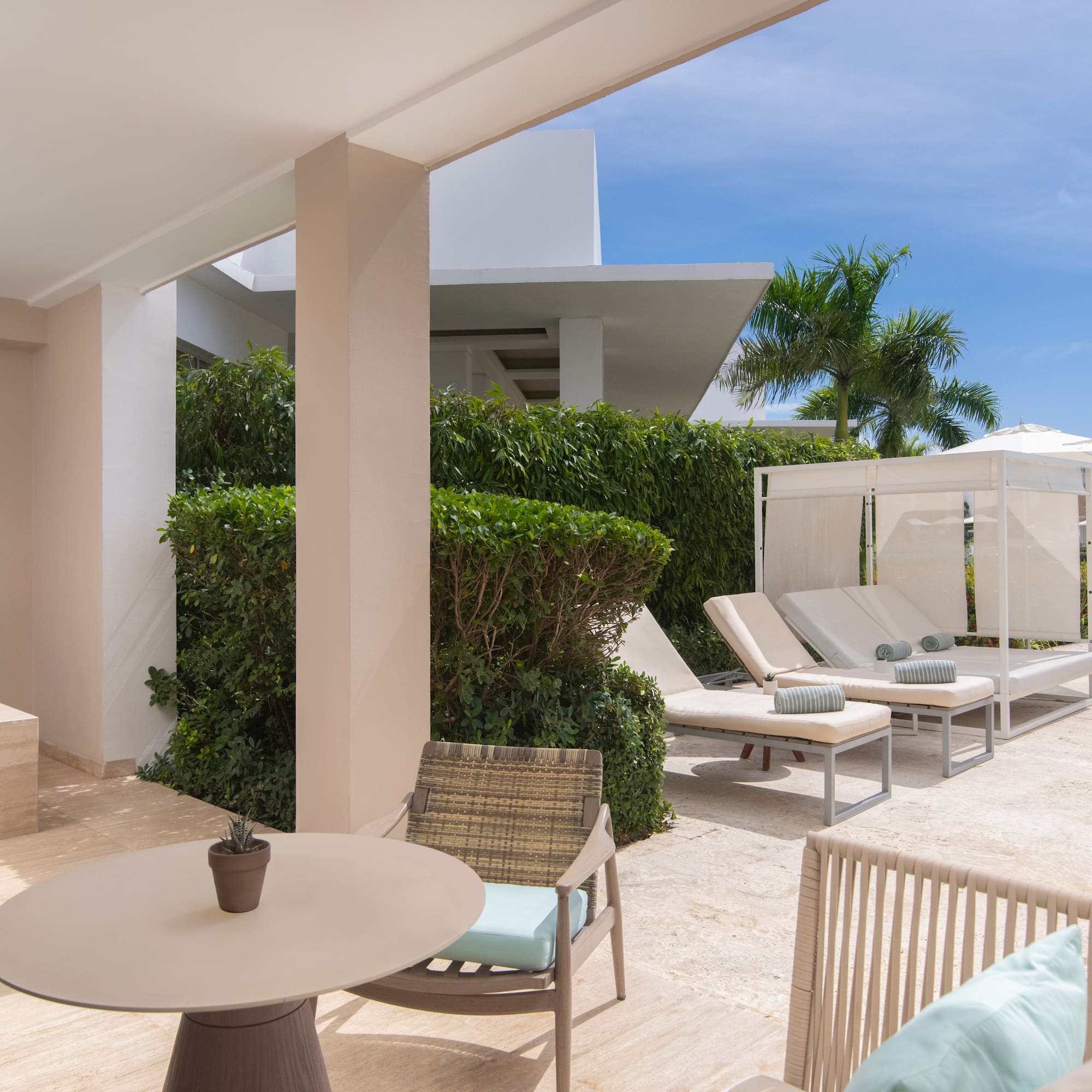 a patio with chairs and a table