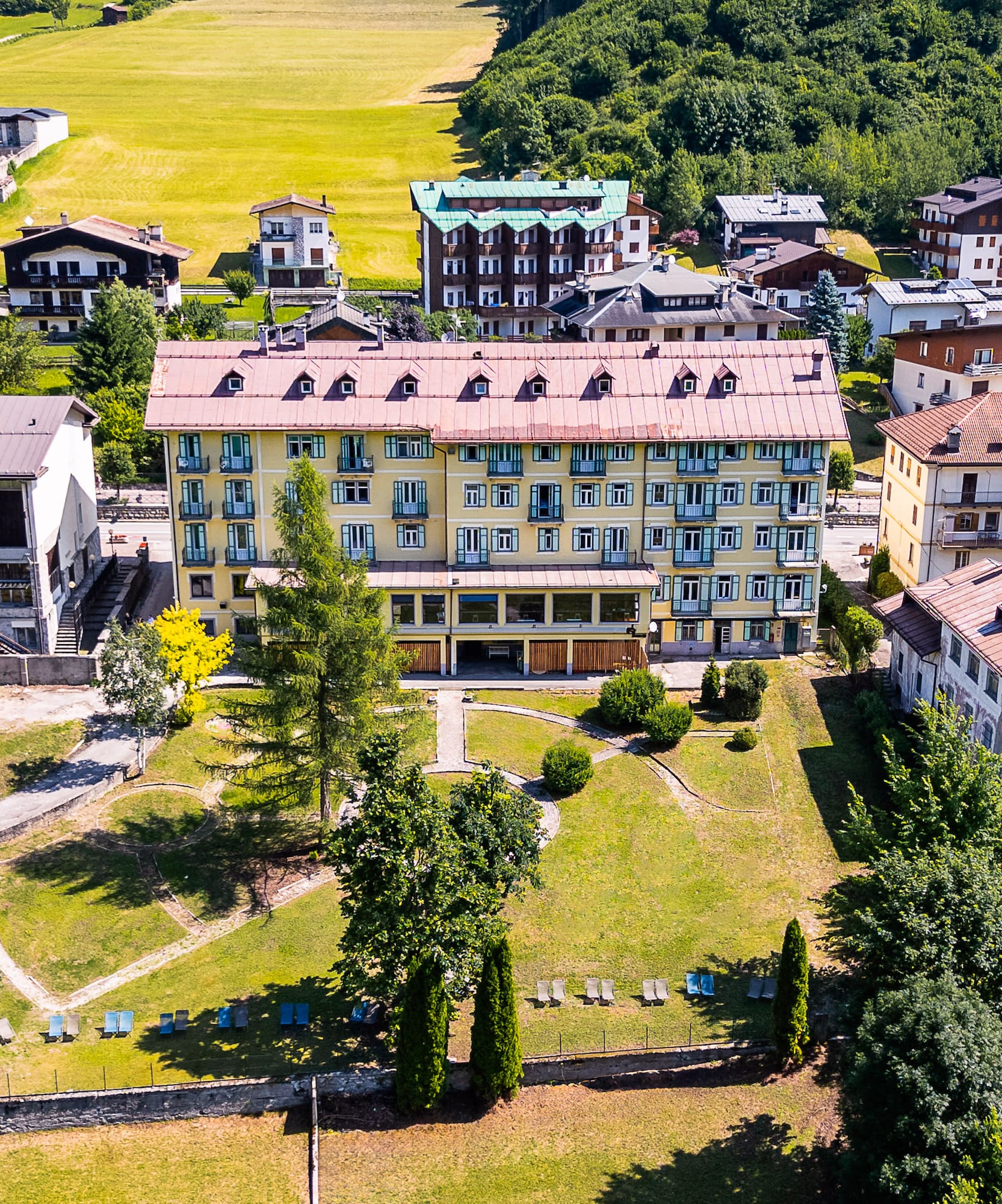 a group of buildings with trees and grass