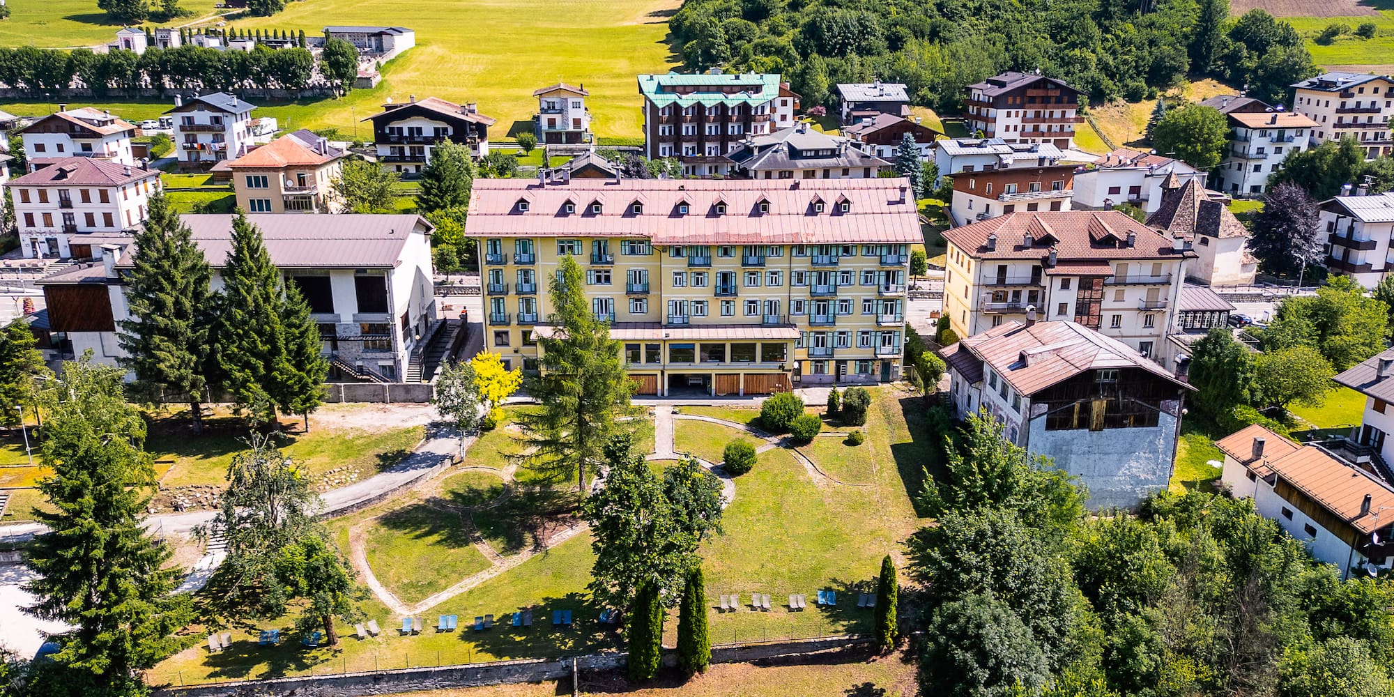a group of buildings with trees and grass