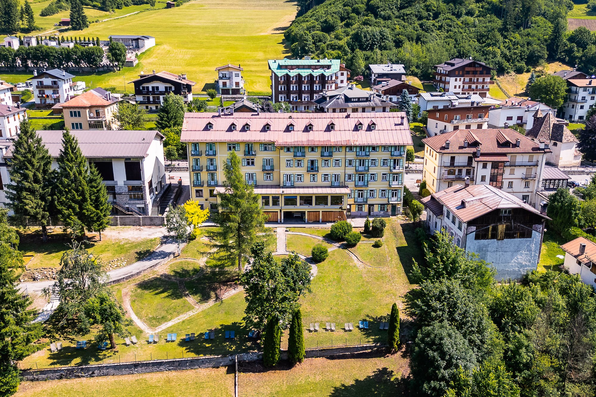 a group of buildings with trees and grass