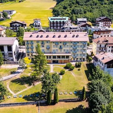 a group of buildings with trees and grass