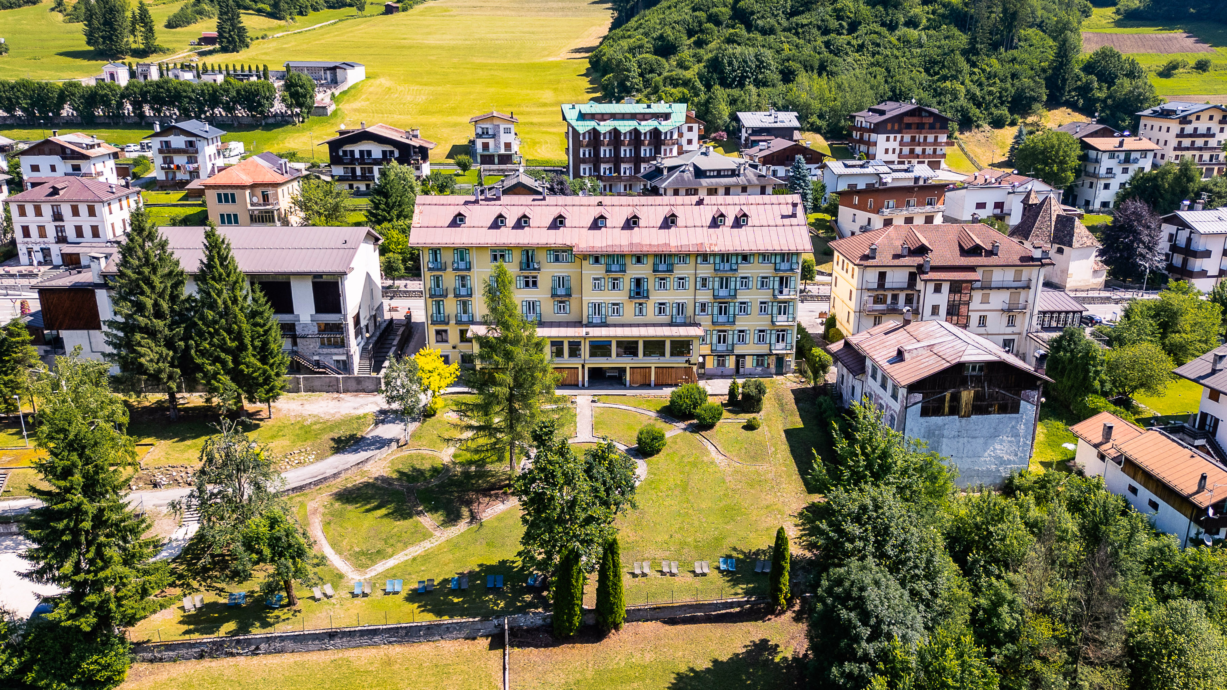 a group of buildings with trees and grass