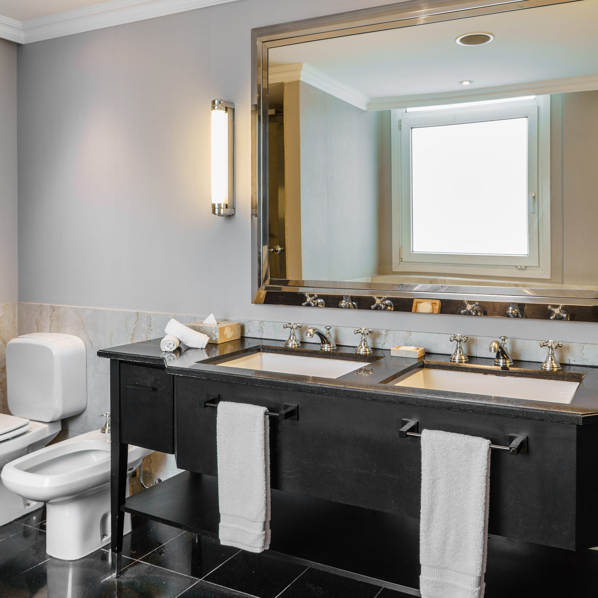 a bathroom with a large mirror and sinks