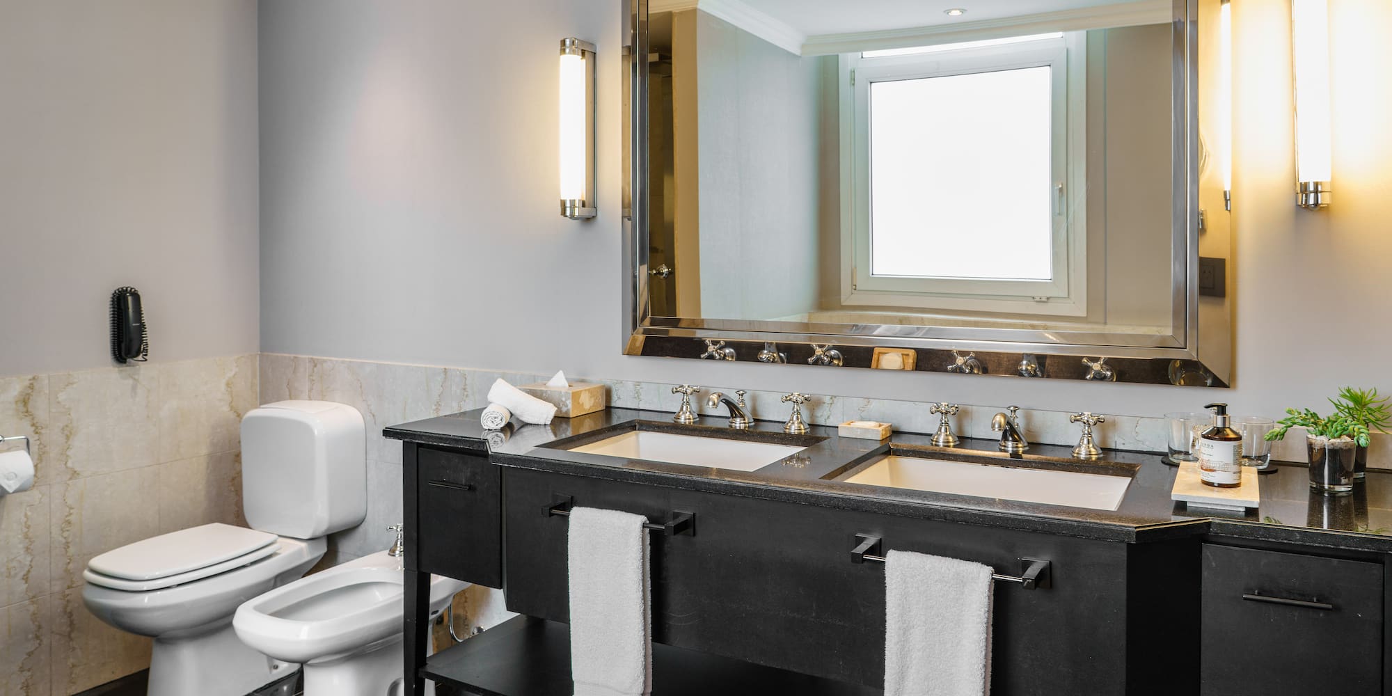 a bathroom with a large mirror and sinks