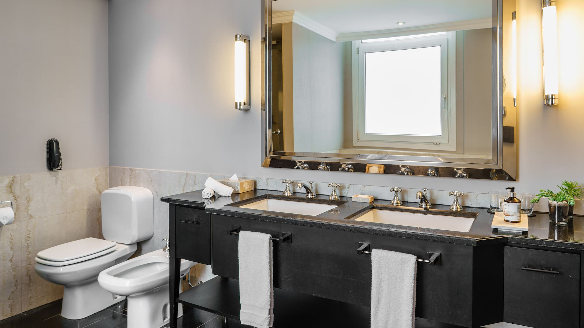 a bathroom with a large mirror and sinks