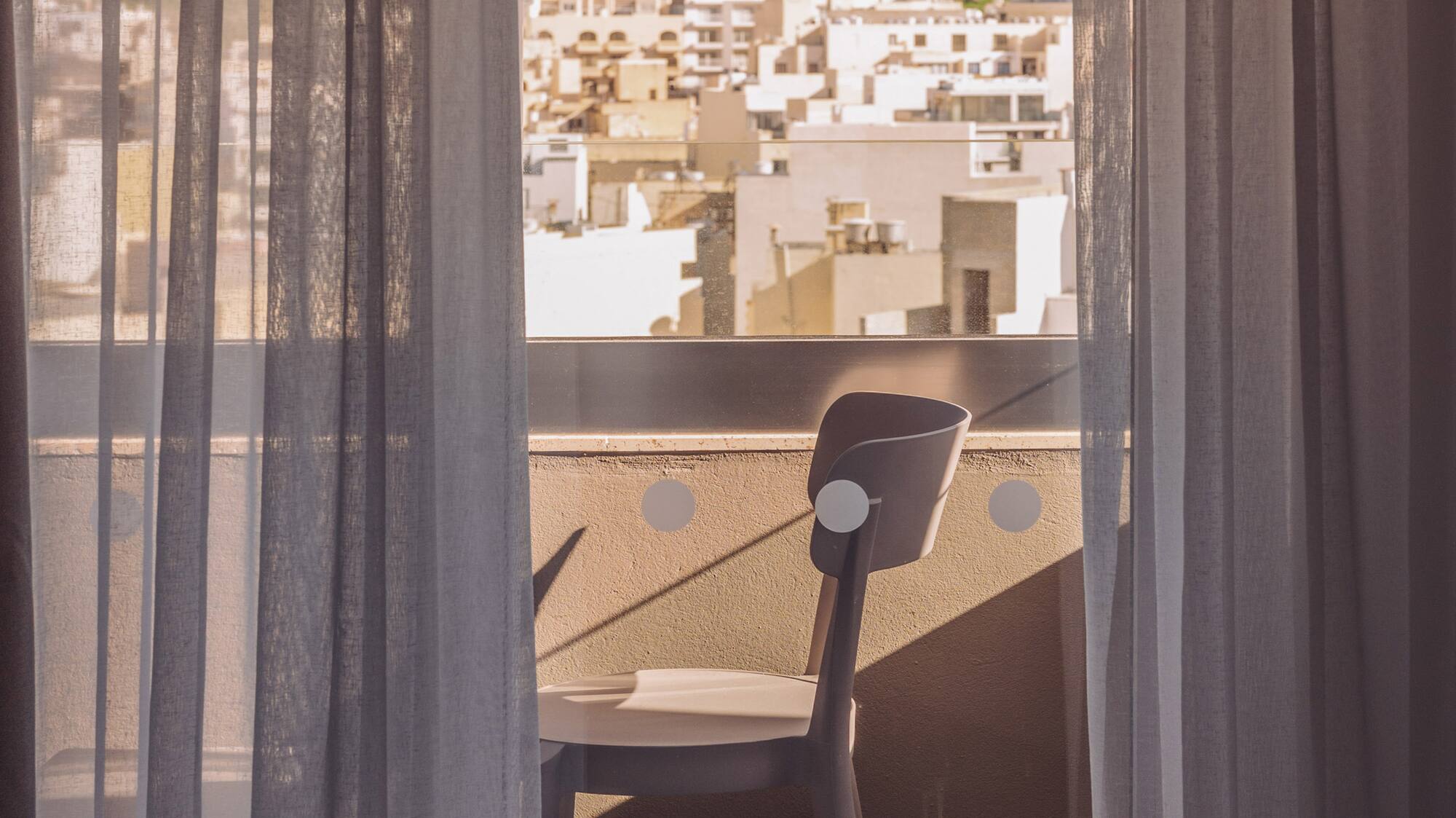 a chair and a window with curtains