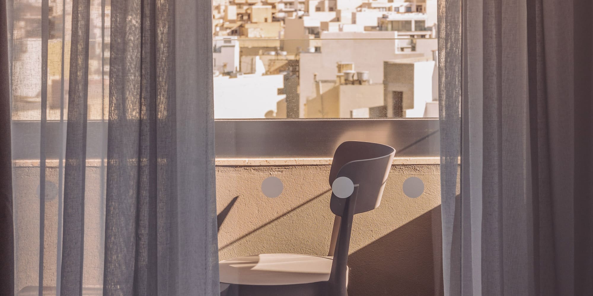 a chair and a window with curtains