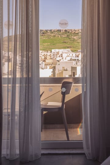 a chair and a window with curtains