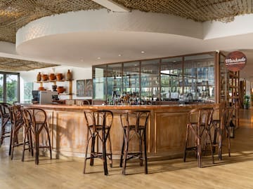 a bar with chairs and a counter
