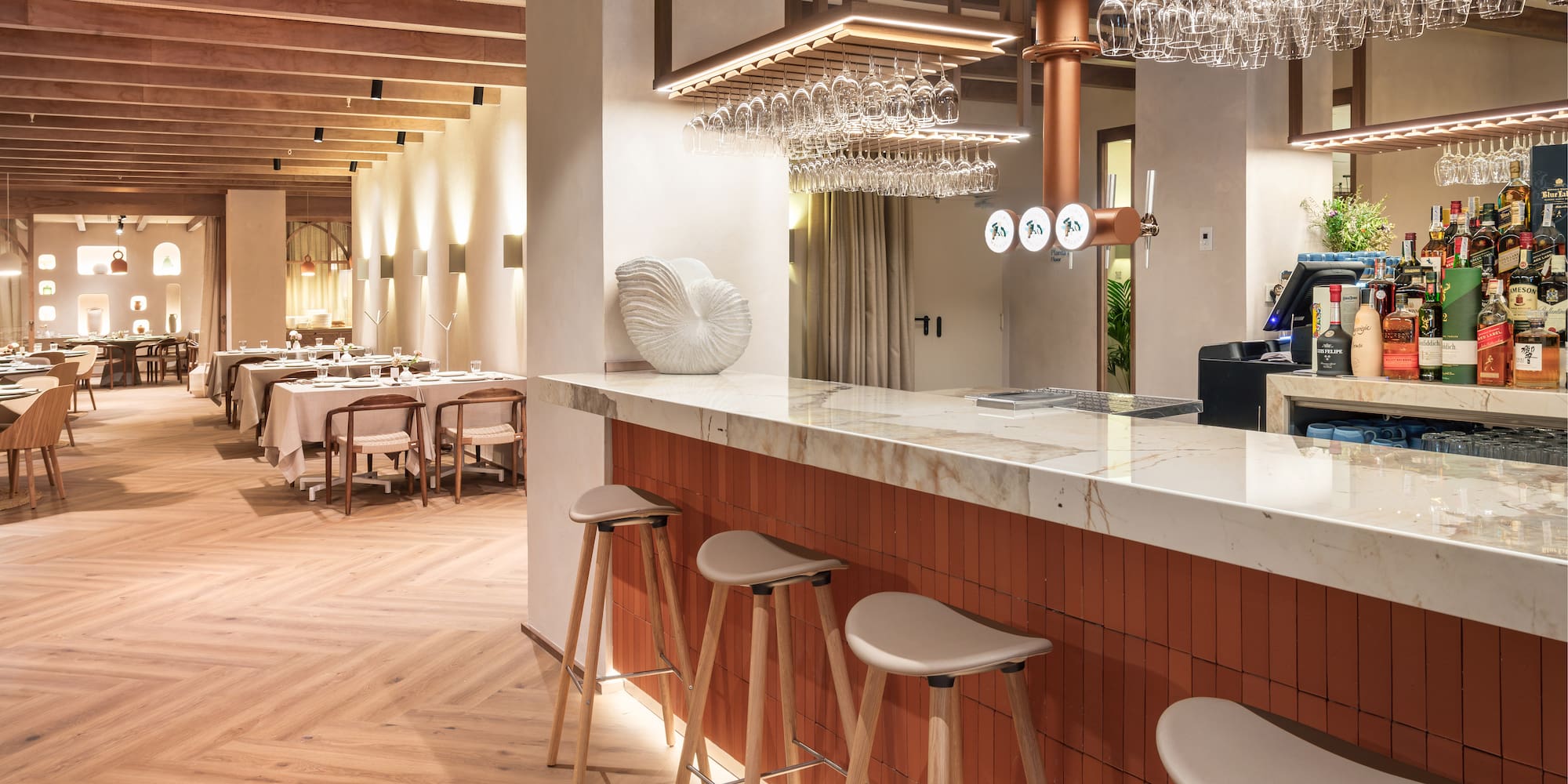 a bar with a counter and chairs in a restaurant