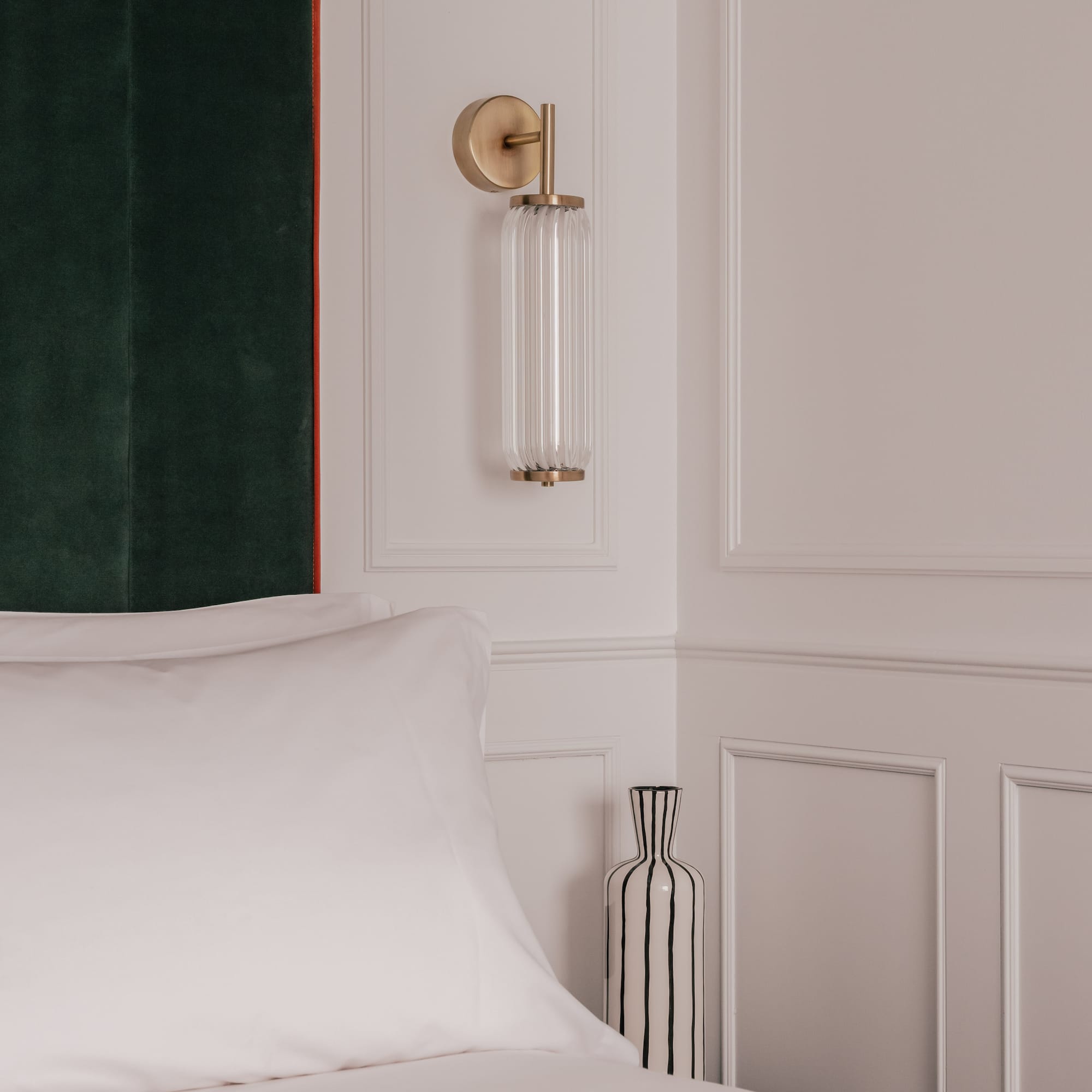 a bed with pillows and a curtain