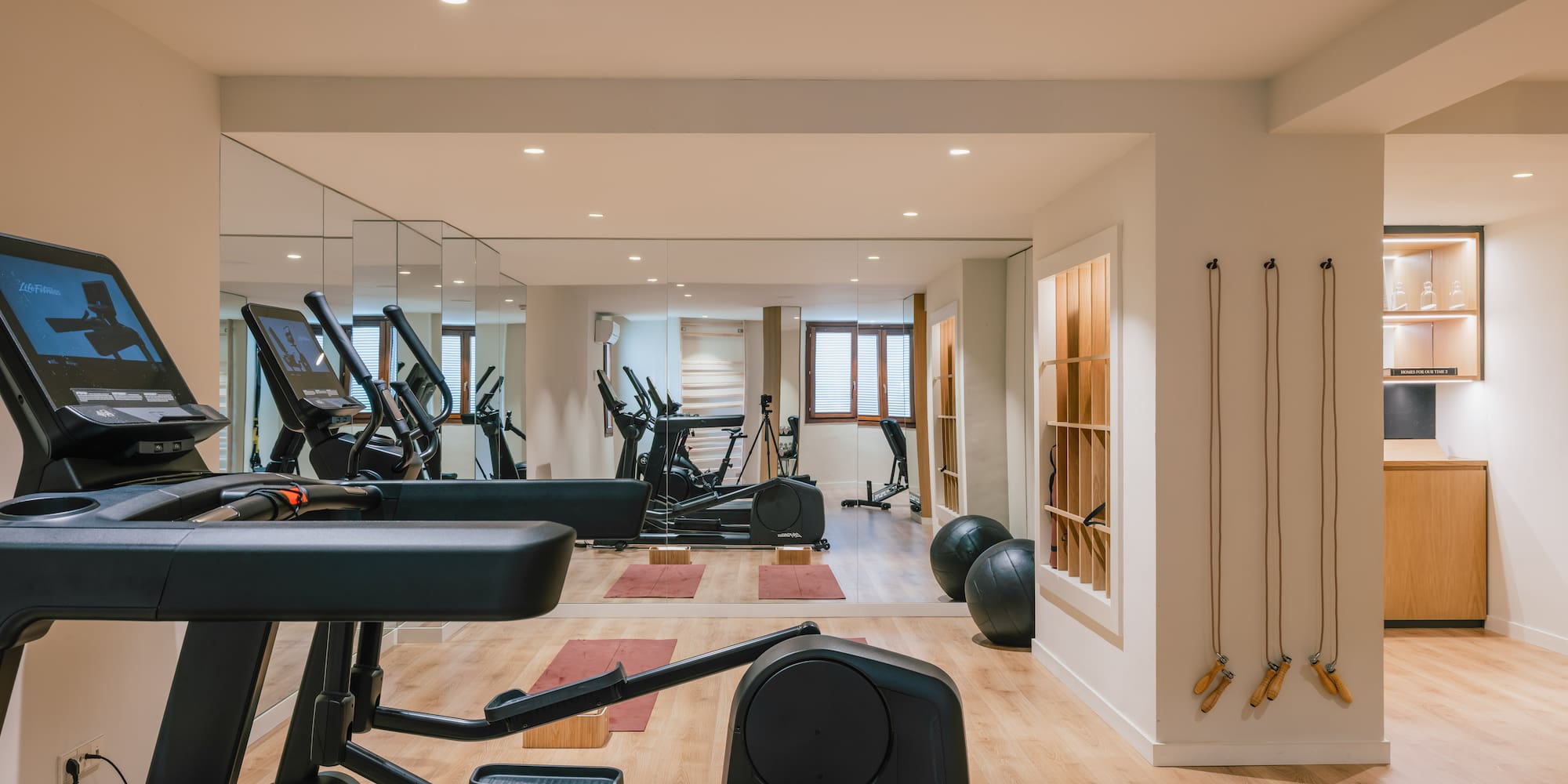a room with exercise equipment and exercise balls