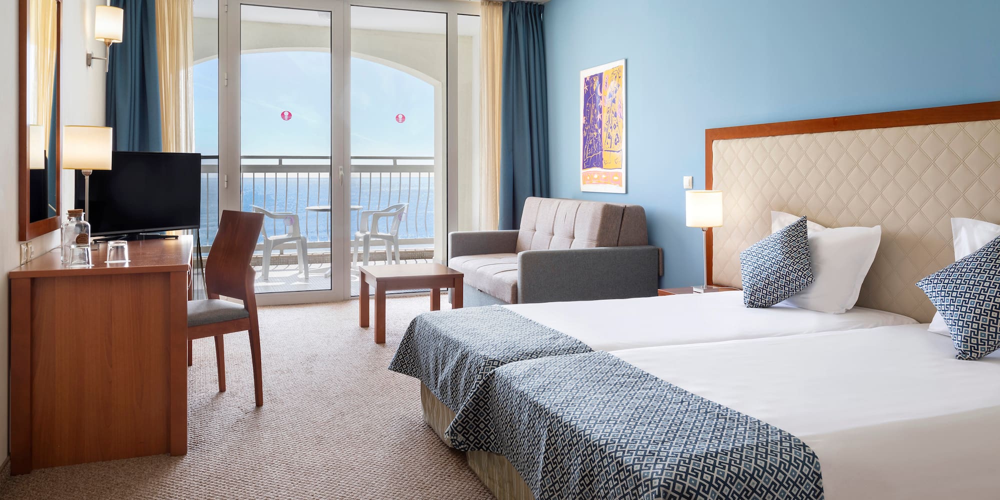 a room with two beds and a television