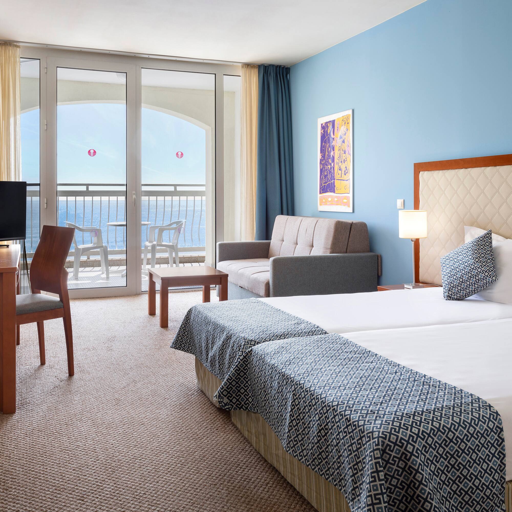 a room with two beds and a television