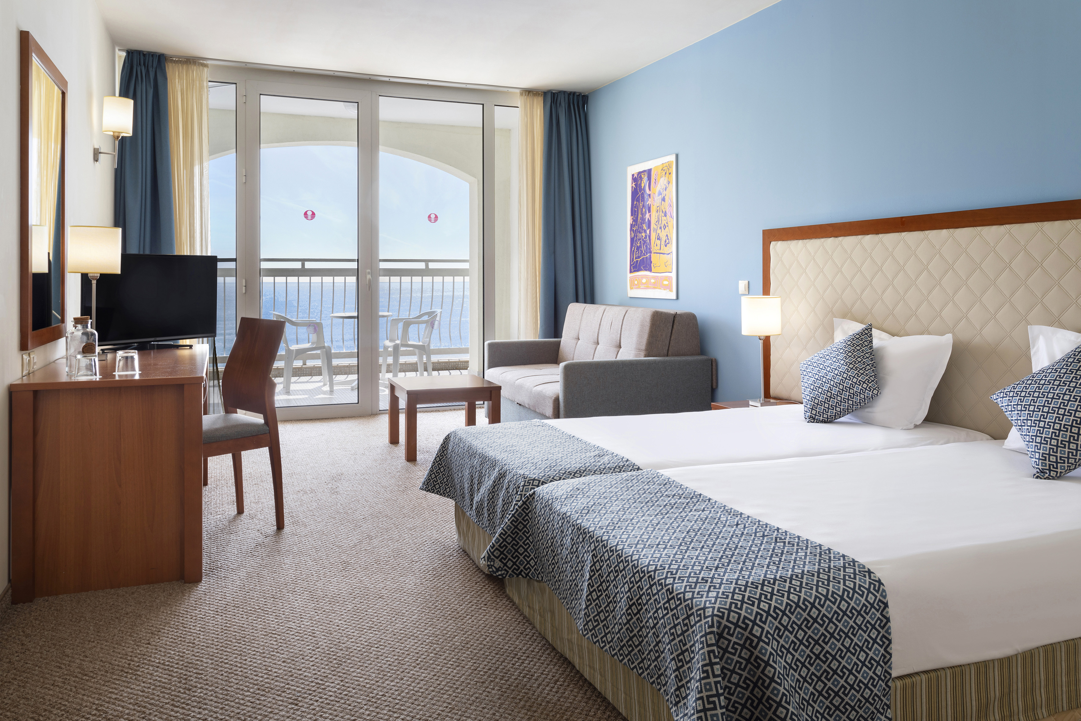 a room with two beds and a television