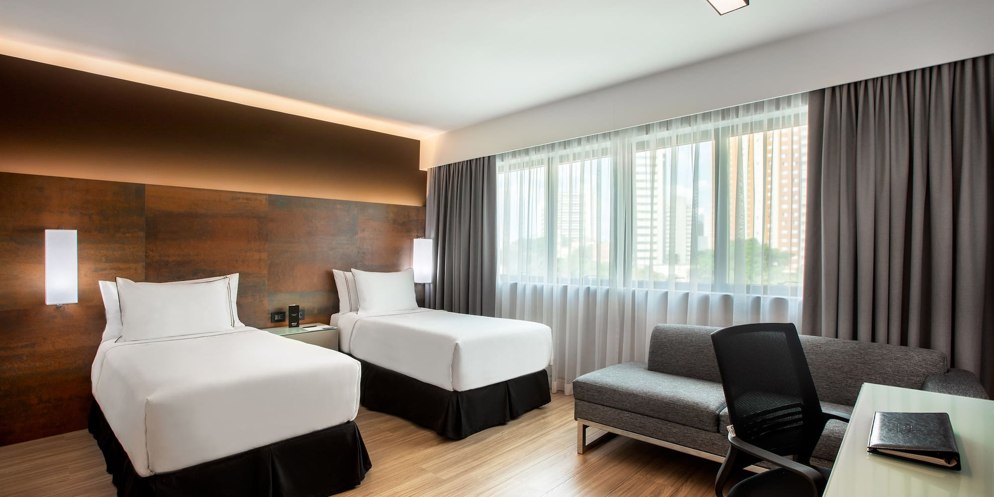 a room with two beds and a chair