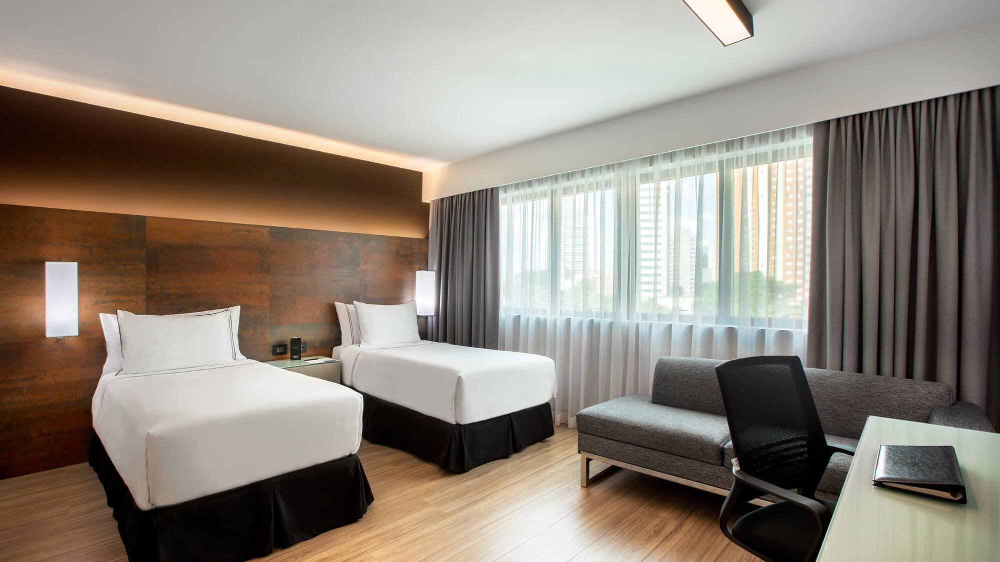 a room with two beds and a chair