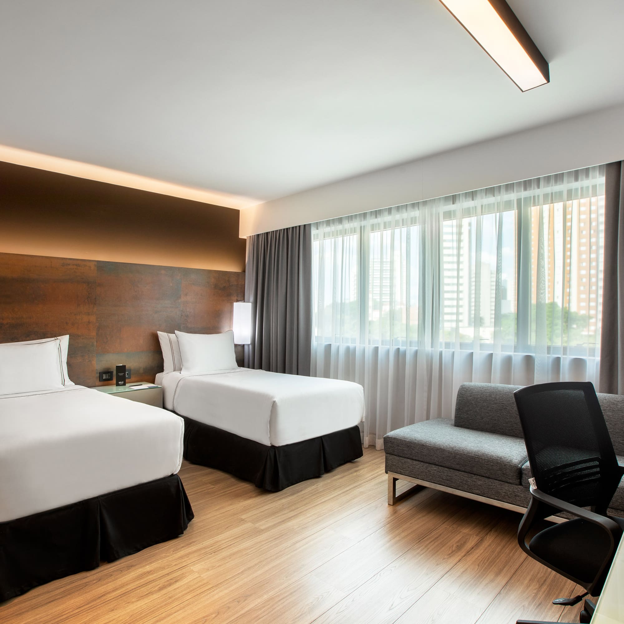 a room with two beds and a chair