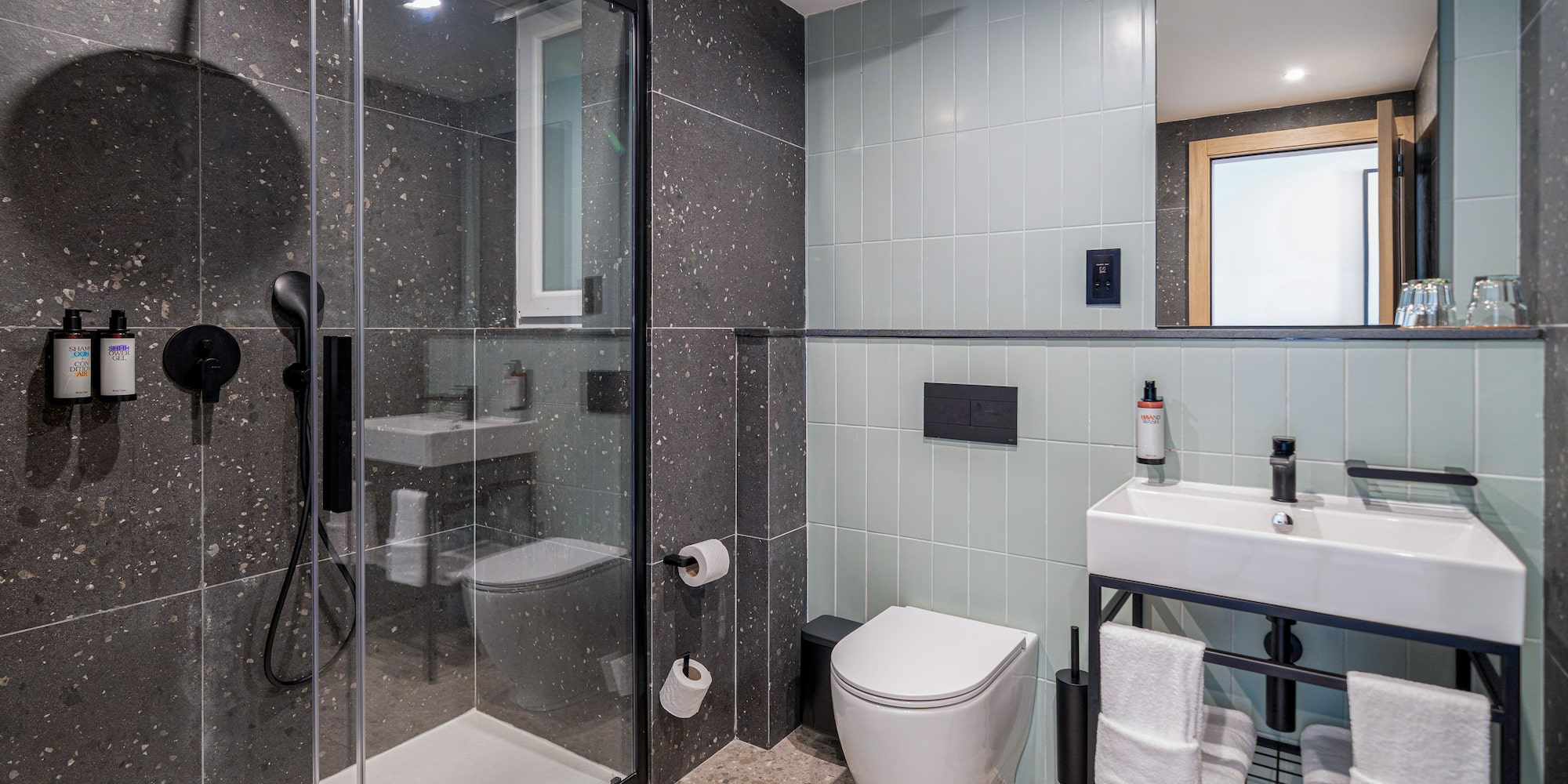 a bathroom with a glass shower and sink