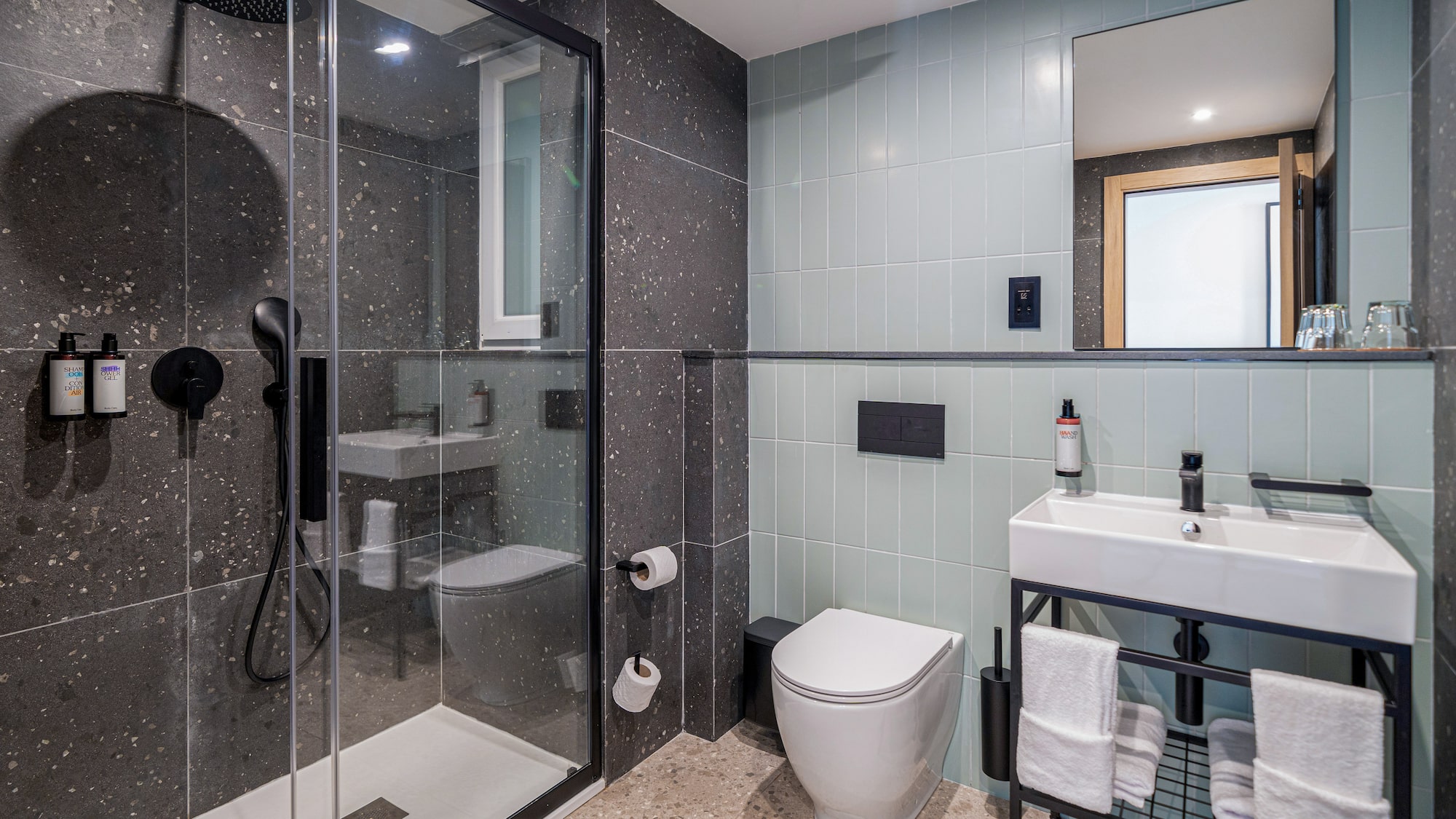 a bathroom with a glass shower and sink