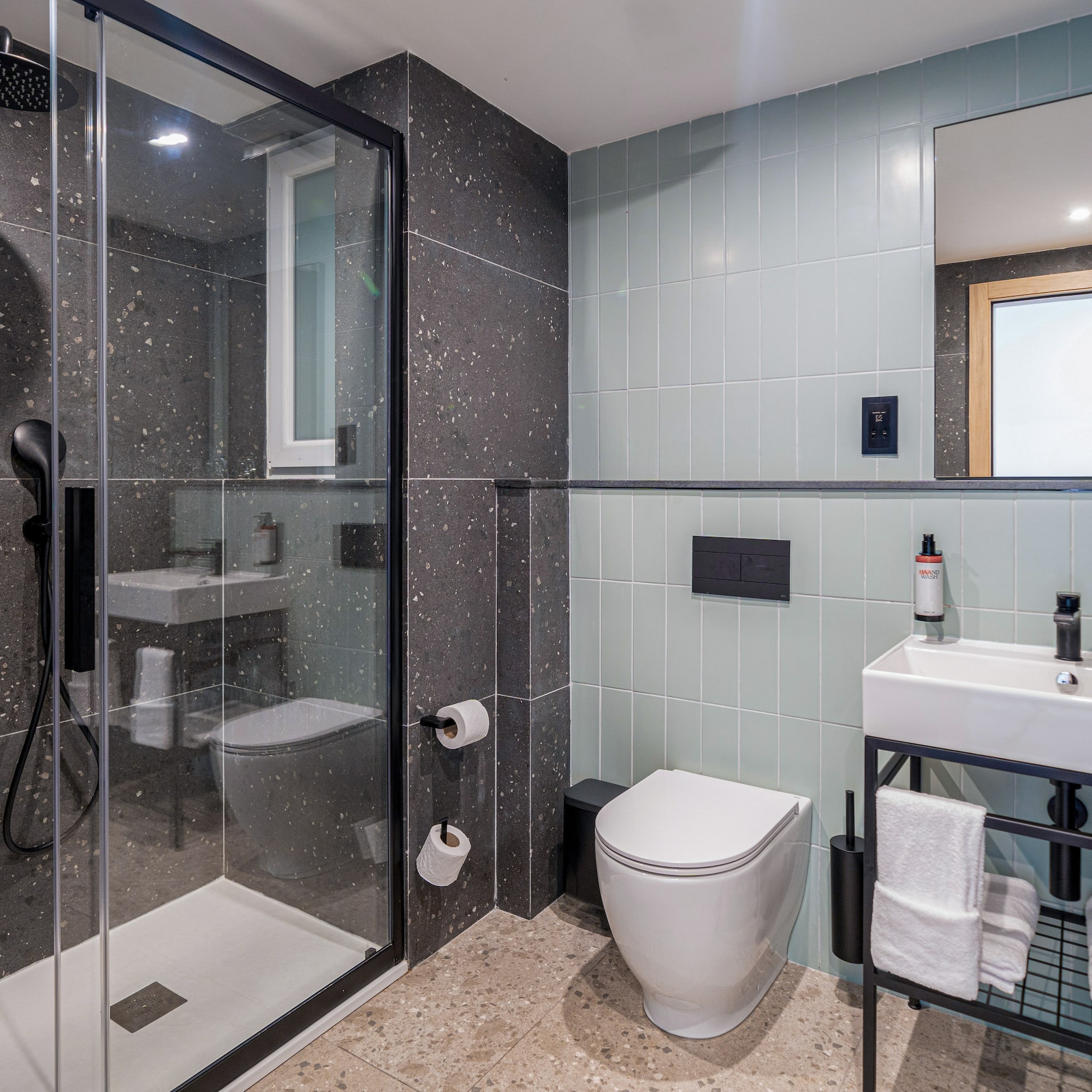a bathroom with a glass shower and sink