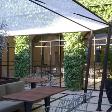 a patio with tables and chairs