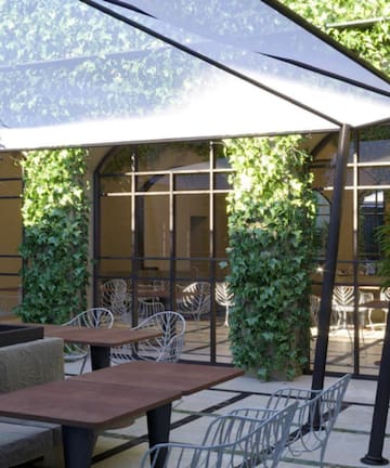 a patio with tables and chairs