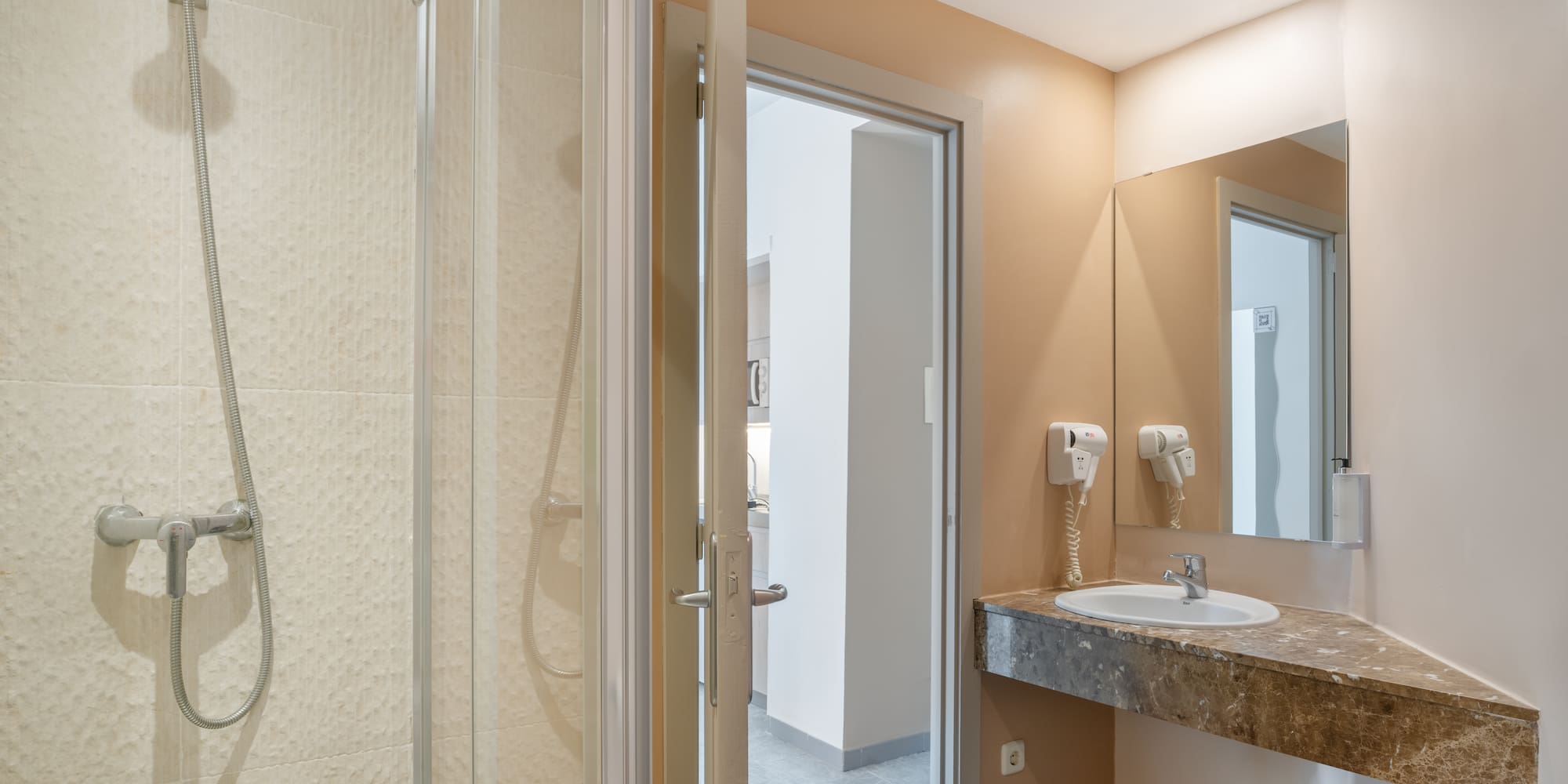 a bathroom with a shower and sink