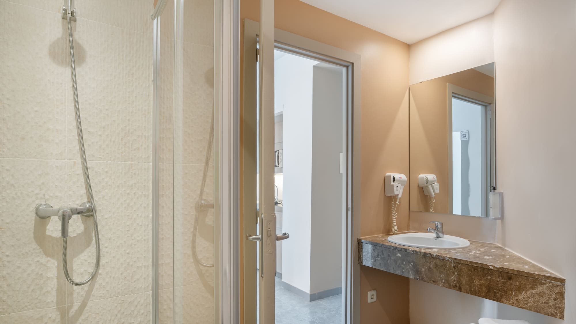 a bathroom with a shower and sink