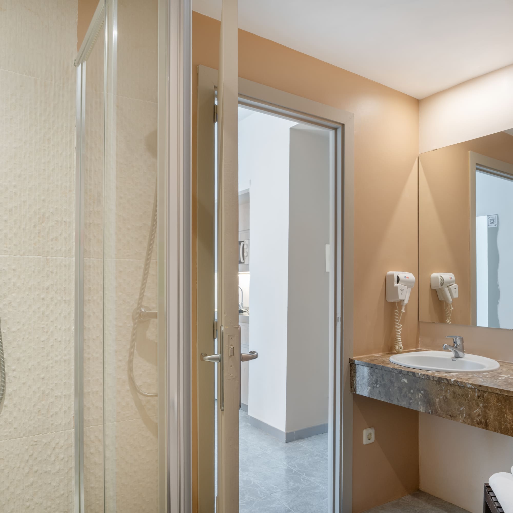 a bathroom with a shower and sink