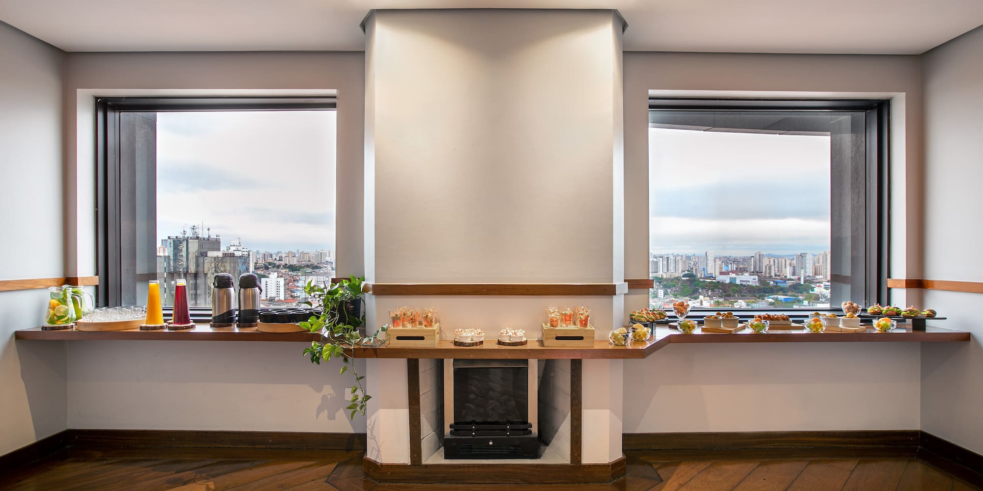 a room with a fireplace and a view of a city