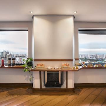 a room with a fireplace and a view of a city
