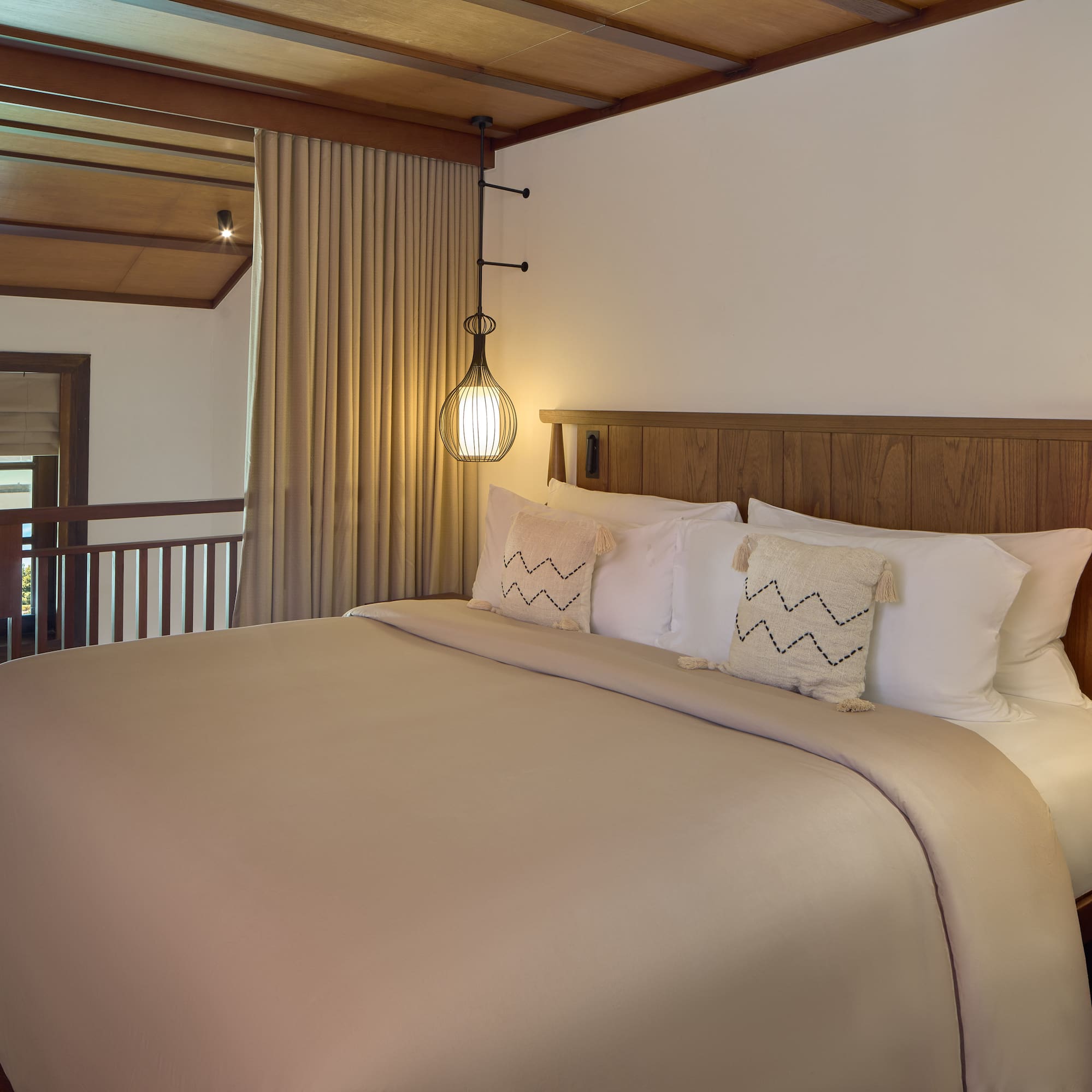 a bed with a wooden headboard and a lamp