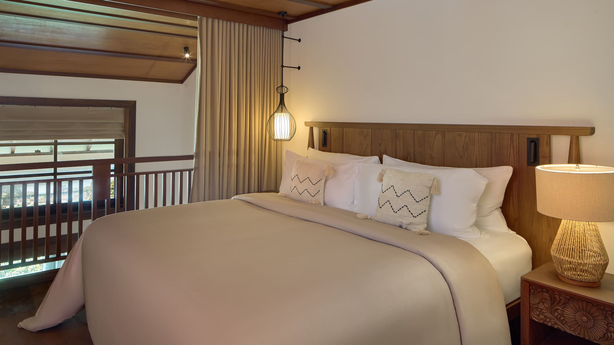 a bed with a wooden headboard and a lamp